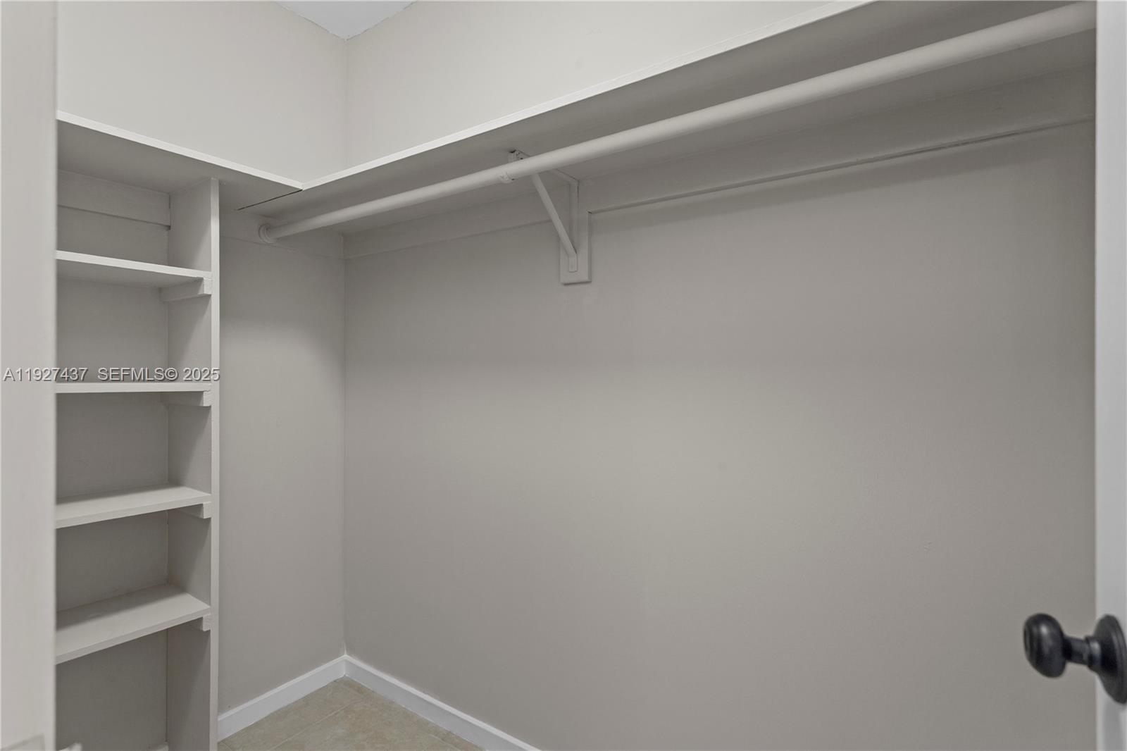 9511 Collins Avenue, Unit 806 Surfside, FL 33154 - Photo 20 of 32 a view of an empty walk in closet