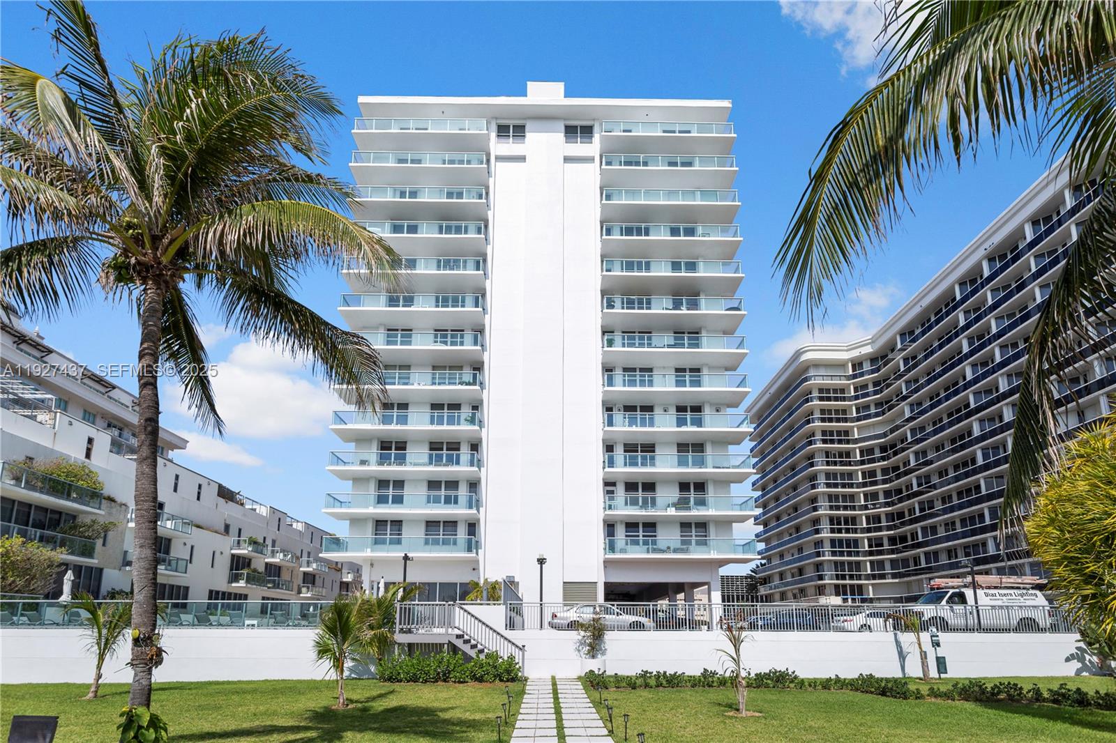 9511 Collins Avenue, Unit 806 Surfside, FL 33154 - Photo 28 of 32 a front view of a multi story building with yard