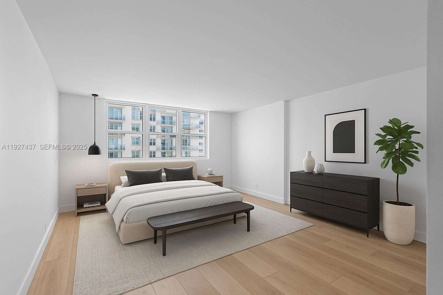 9511 Collins Avenue, Unit 806 Surfside, FL 33154 - Photo 3 of 32 a bedroom with a bed and a potted plant