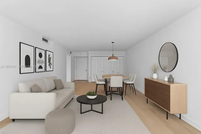 a living room with furniture a mirror and a lamp