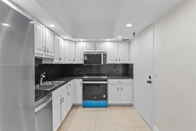 a kitchen with stainless steel appliances granite countertop a stove and a refrigerator