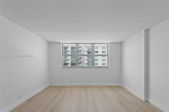 a view of an empty room with a window