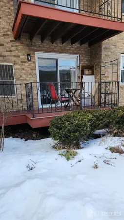 a view of a chairs and table in backyard