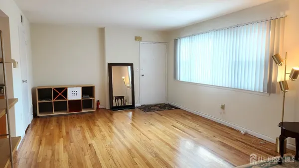 a view of a room with wooden floor and window
