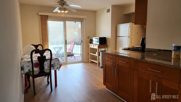 a view of a workspace with furniture and a window