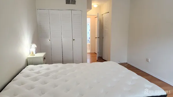 a bedroom with a bed and a lamp