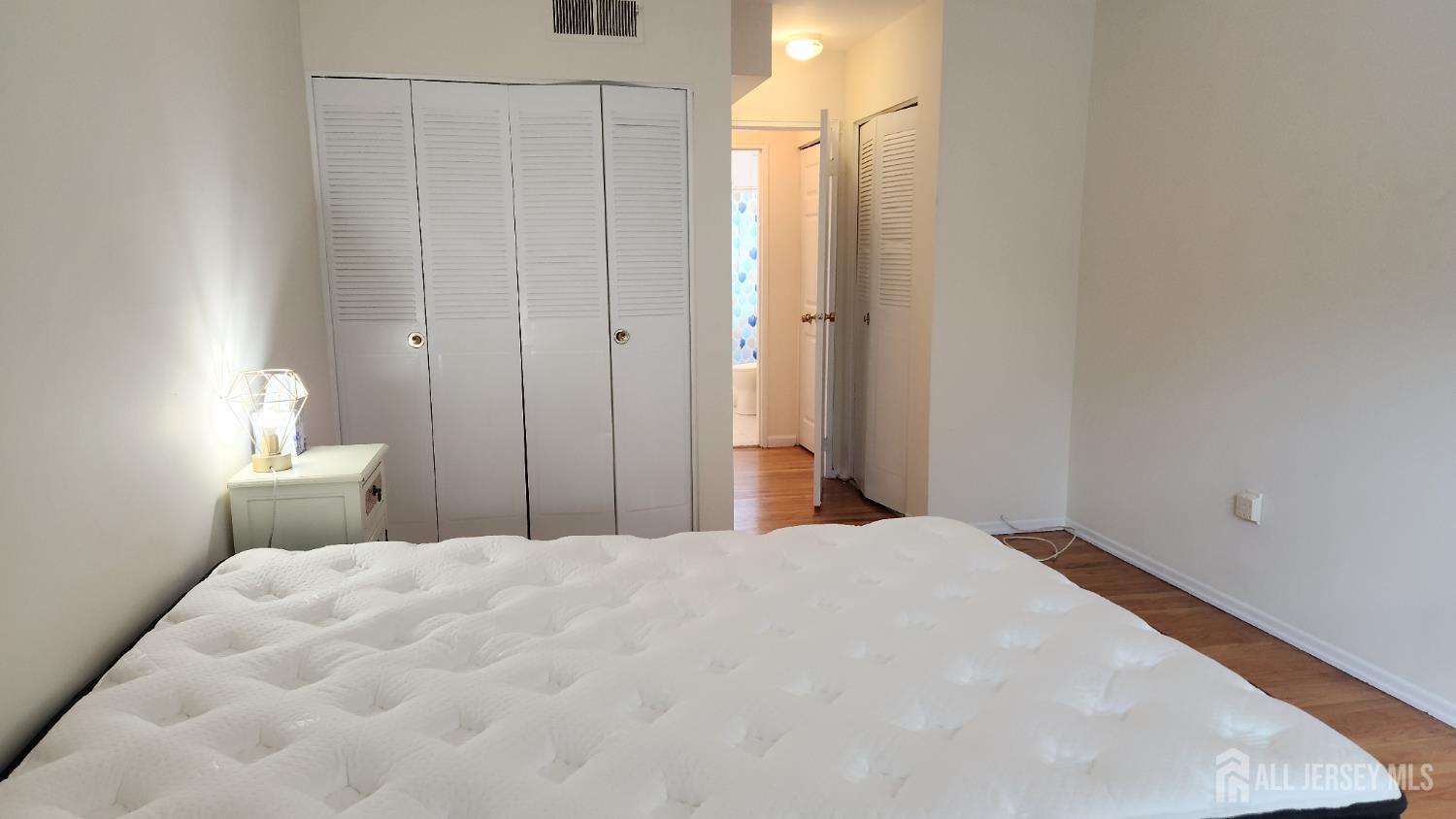 182 Evergreen Road, Unit 3A Edison, NJ 08837 - Photo 10 of 13 a bedroom with a bed and a lamp