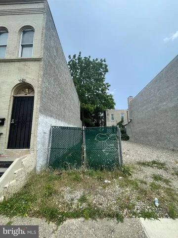 a view of a brick house with a yard