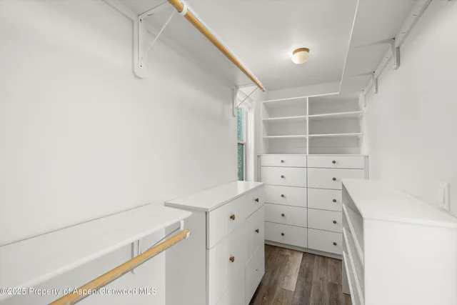 a front view of a house with a yard and potted plants