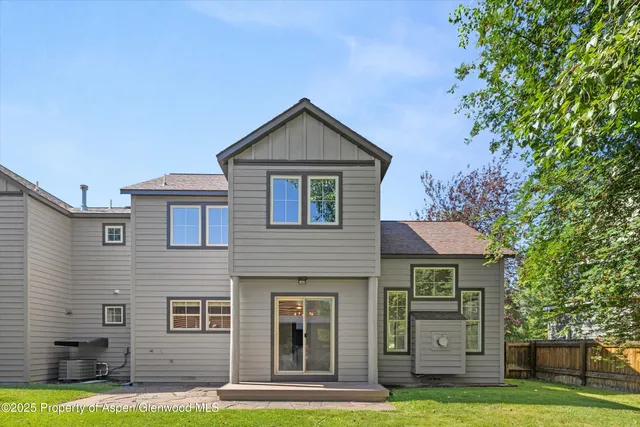a view of a house with a yard and sitting area
