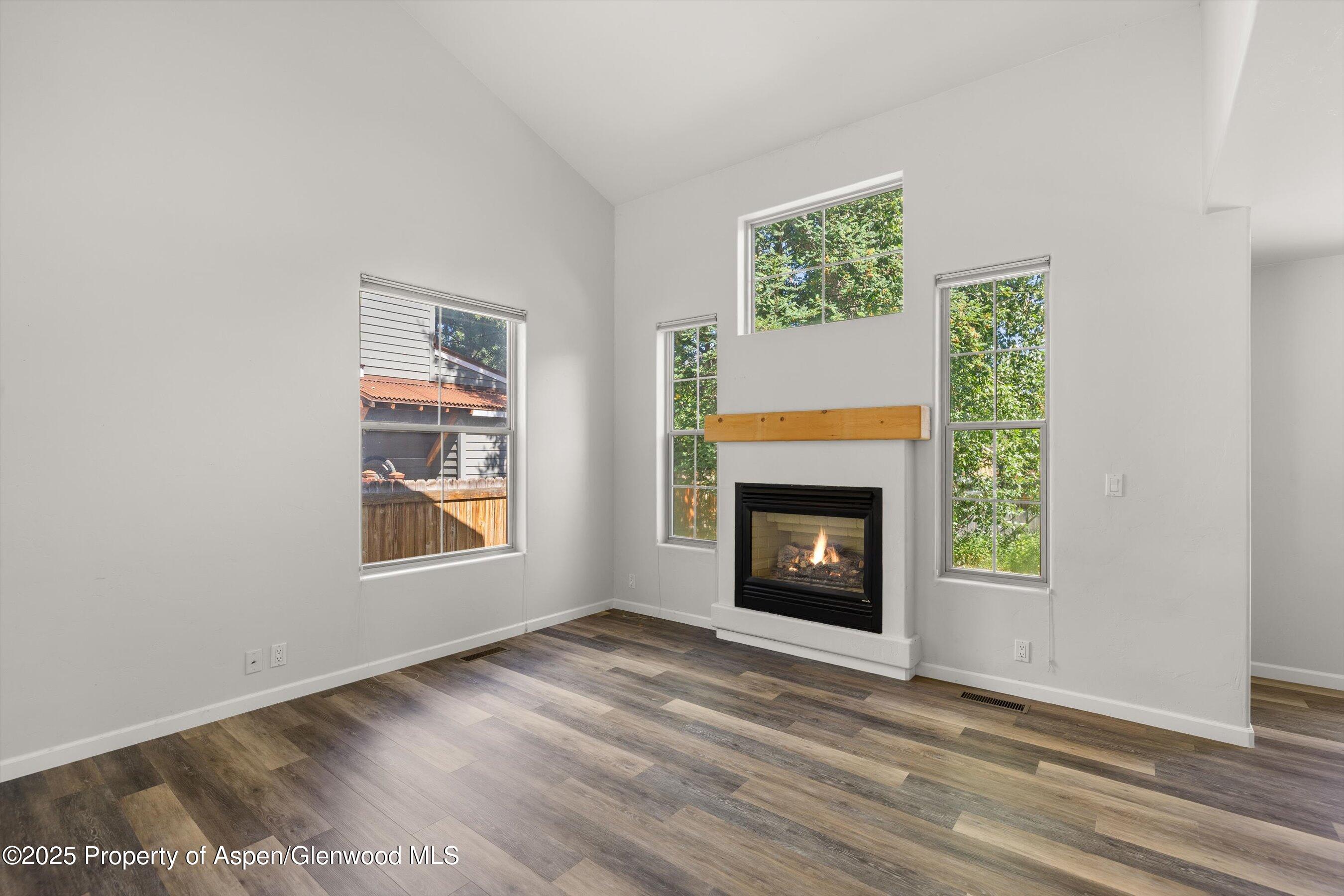 528 Lake Court Basalt, CO 81621 - Photo 6 of 33 a view of an empty room with a window and fireplace