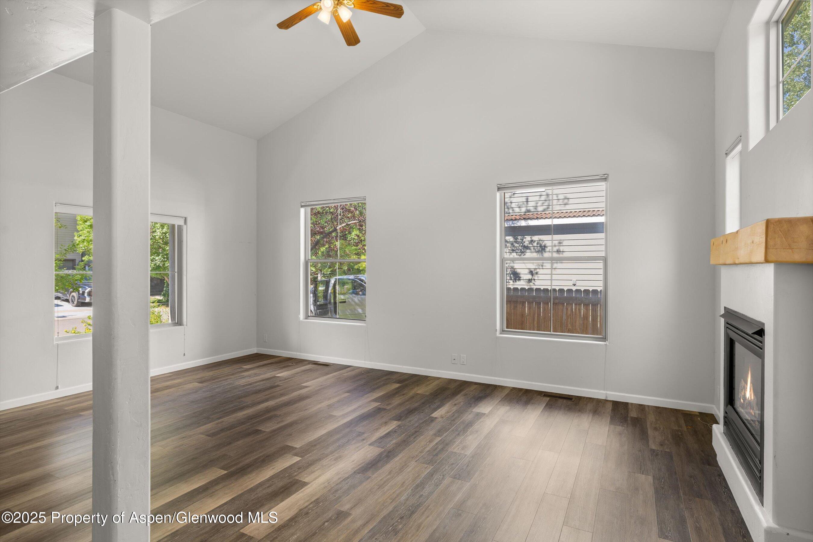 528 Lake Court Basalt, CO 81621 - Photo 8 of 33 an empty room with wooden floor cabinet and windows