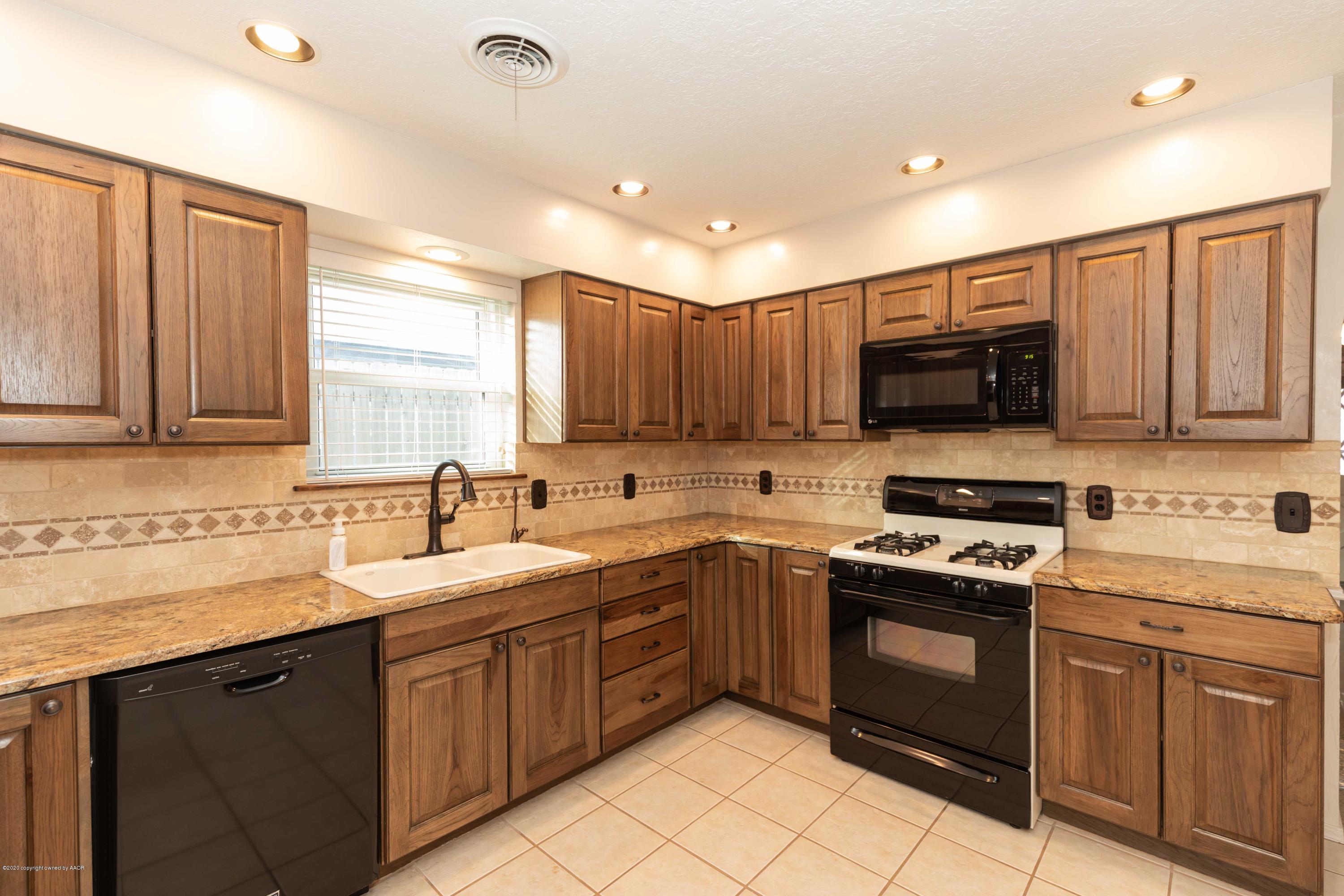 4924 South Georgia Street Amarillo, TX 79110 - Photo 13 of 35 a kitchen with a sink stove and microwave
