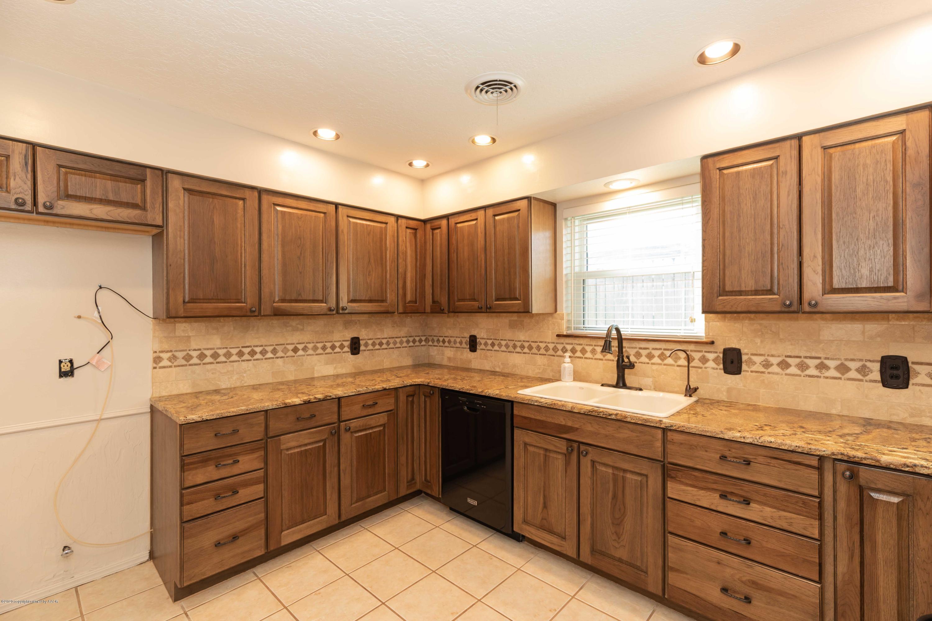 4924 South Georgia Street Amarillo, TX 79110 - Photo 14 of 35 a kitchen with sink cabinets and window