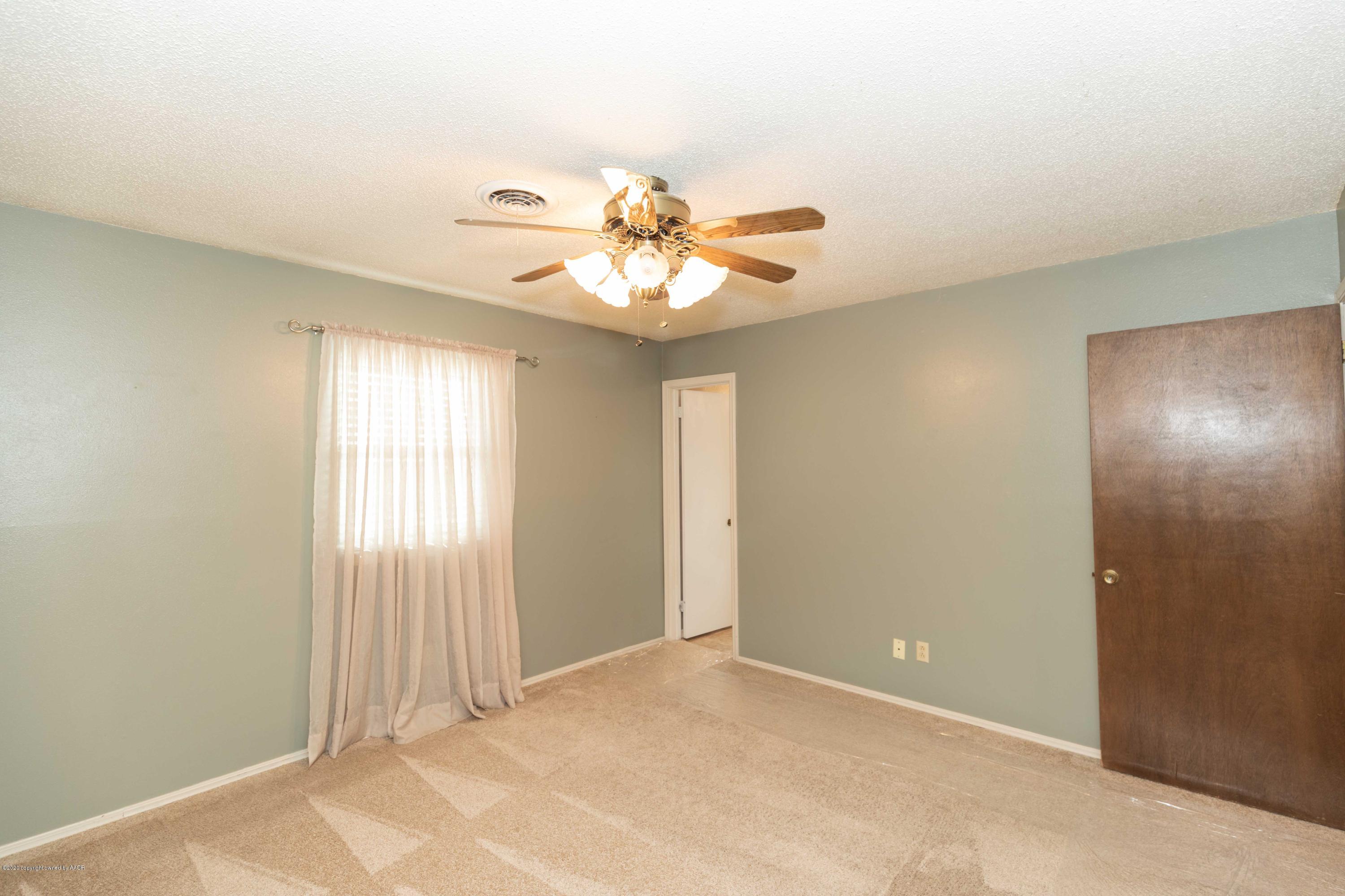 4924 South Georgia Street Amarillo, TX 79110 - Photo 17 of 35 a view of a room with a chandelier fan and windows