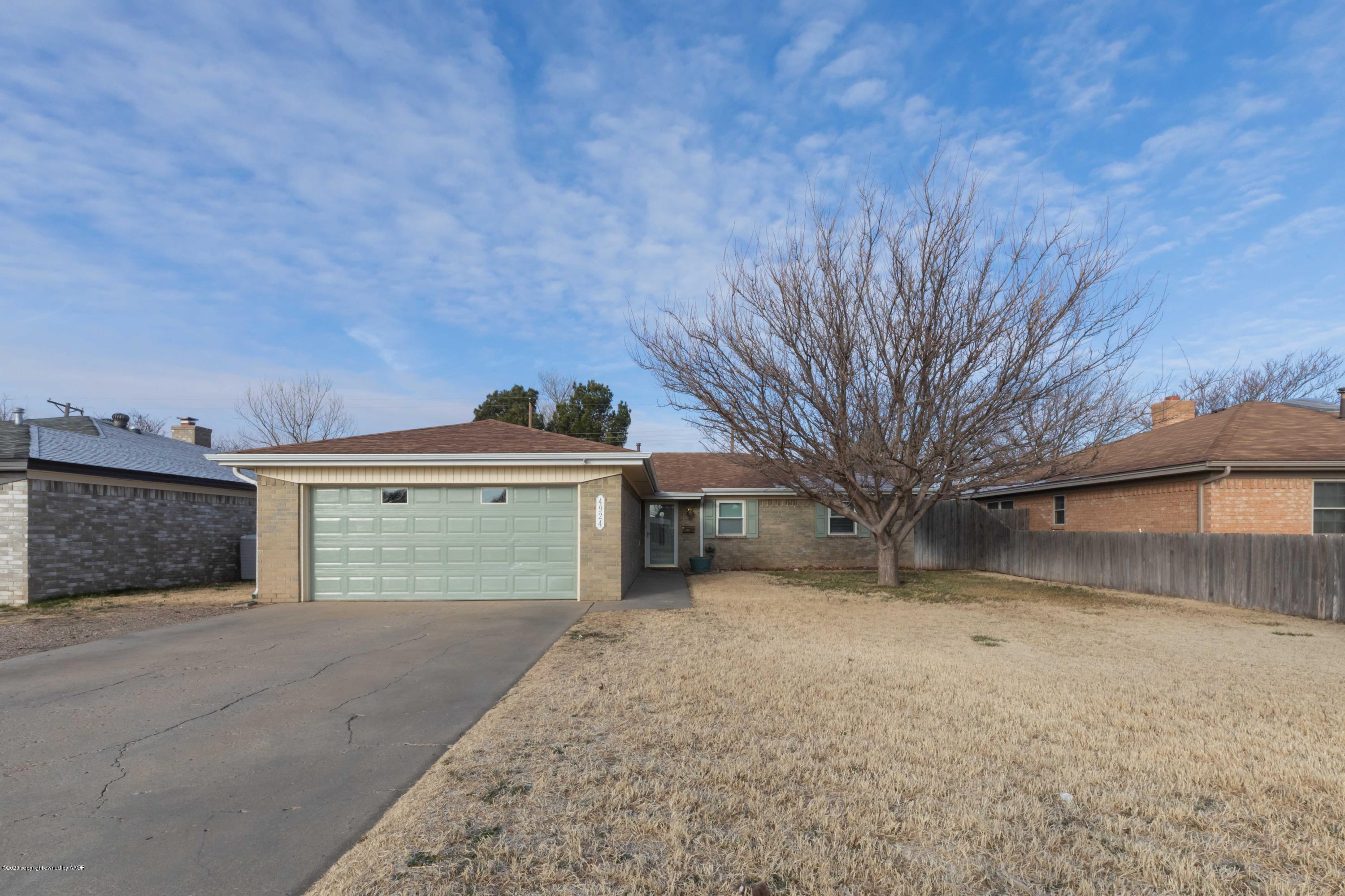 4924 South Georgia Street Amarillo, TX 79110 - Photo 2 of 35 a front view of a house with a yard and garage