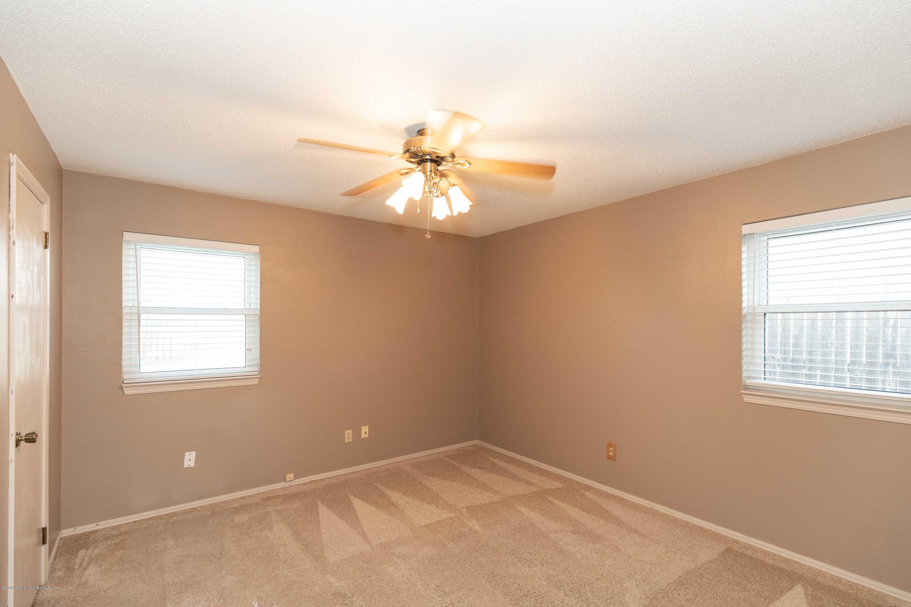 4924 South Georgia Street Amarillo, TX 79110 - Photo 23 of 35 an empty room with windows and chandelier fan