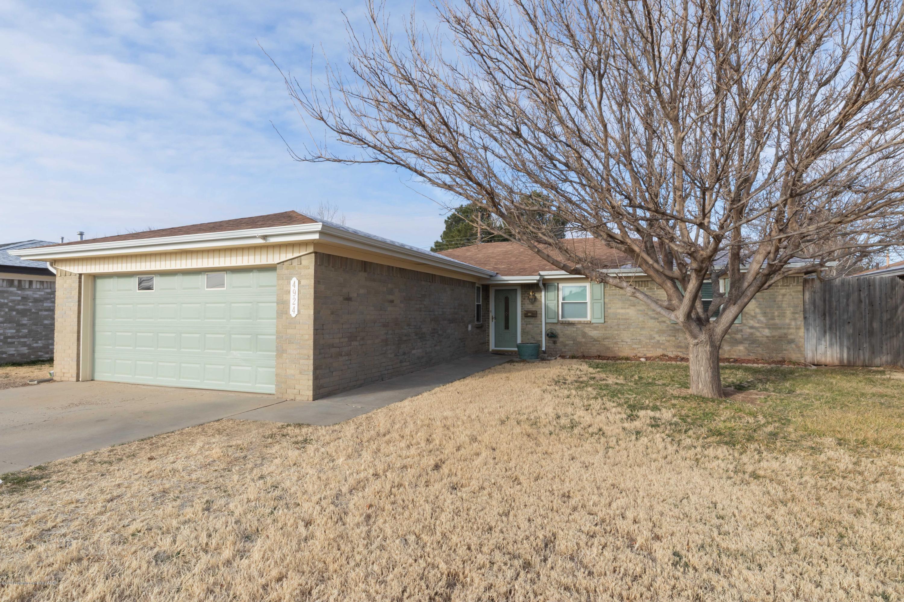 4924 South Georgia Street Amarillo, TX 79110 - Photo 3 of 35 a front view of a house with a yard and garage
