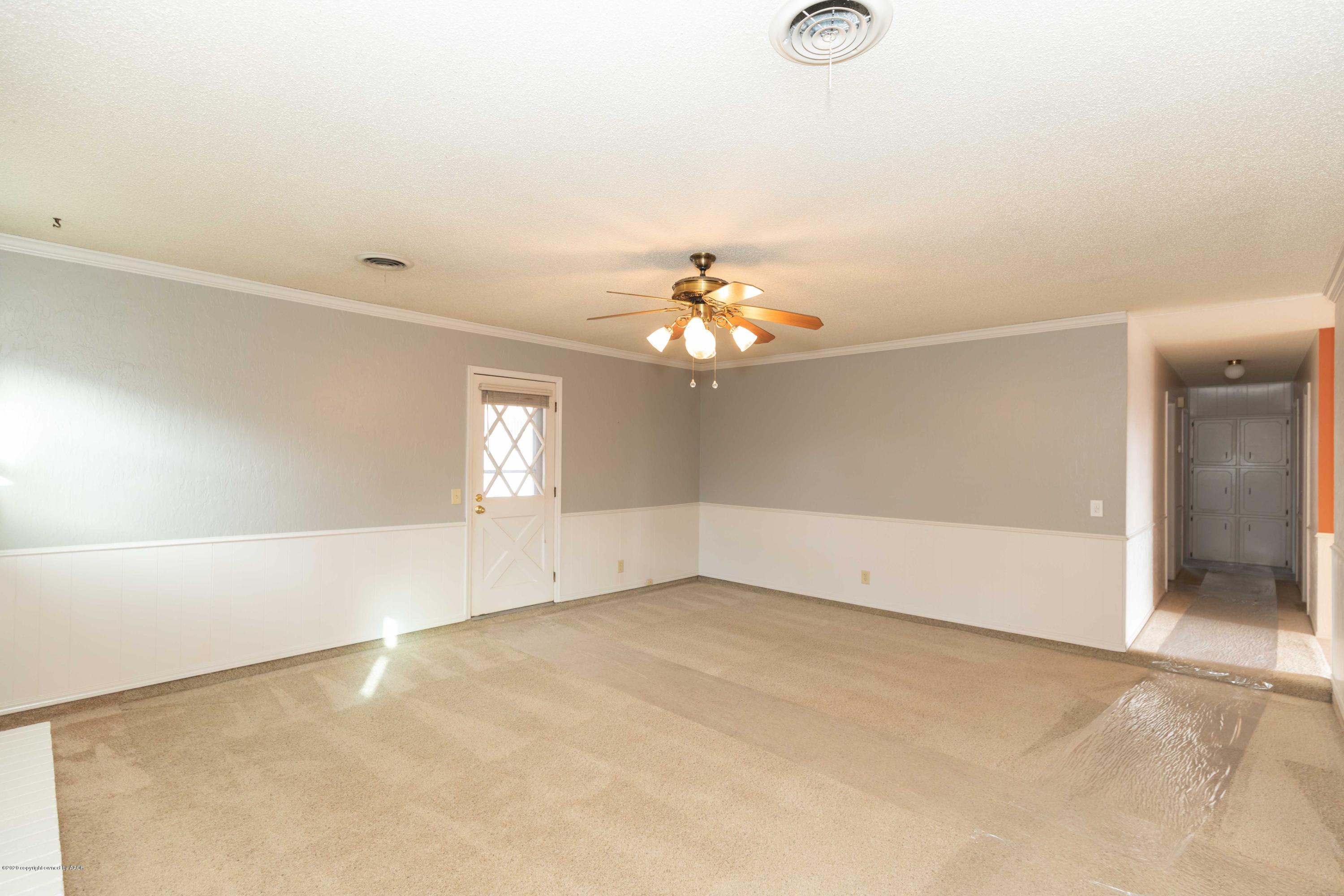 4924 South Georgia Street Amarillo, TX 79110 - Photo 6 of 35 an empty room with chandelier fan and windows