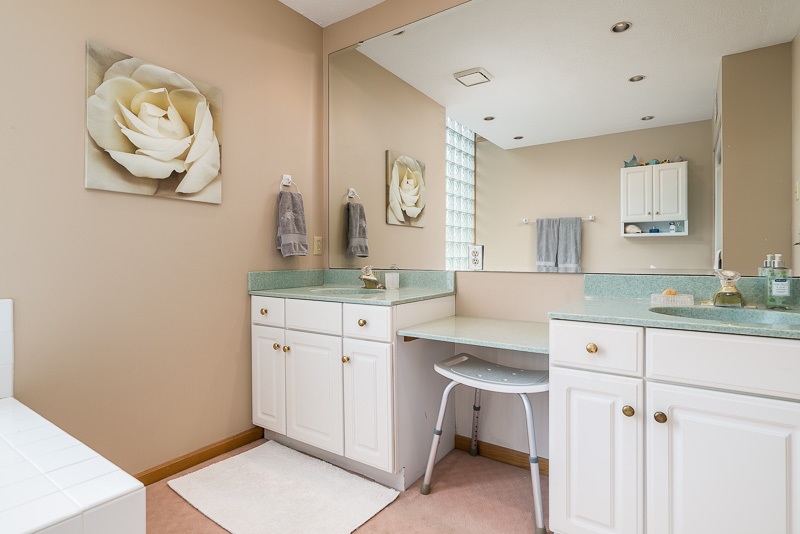 10762 Shaw Road Rockford, IL 61114 - Photo 24 of 25 a spacious bathroom with a granite countertop sink and a mirror