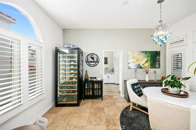 a living room with furniture a chandelier and a window