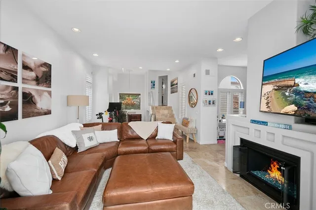 a living room with furniture a fireplace and a flat screen tv