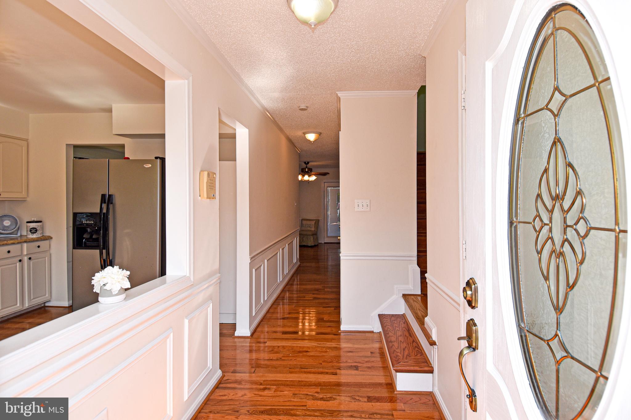 8482 Stonewall Road Manassas, VA 20110 - Photo 2 of 36 As you enter open views of hardwood hallway