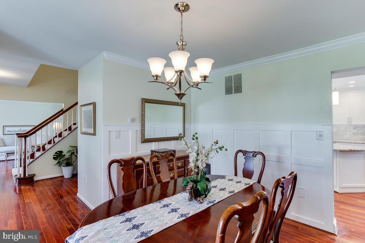 7883 Poplar Grove Road Severn, MD 21144 - Photo 10 of 77 a view of a dining room with furniture wooden floor and chandelier