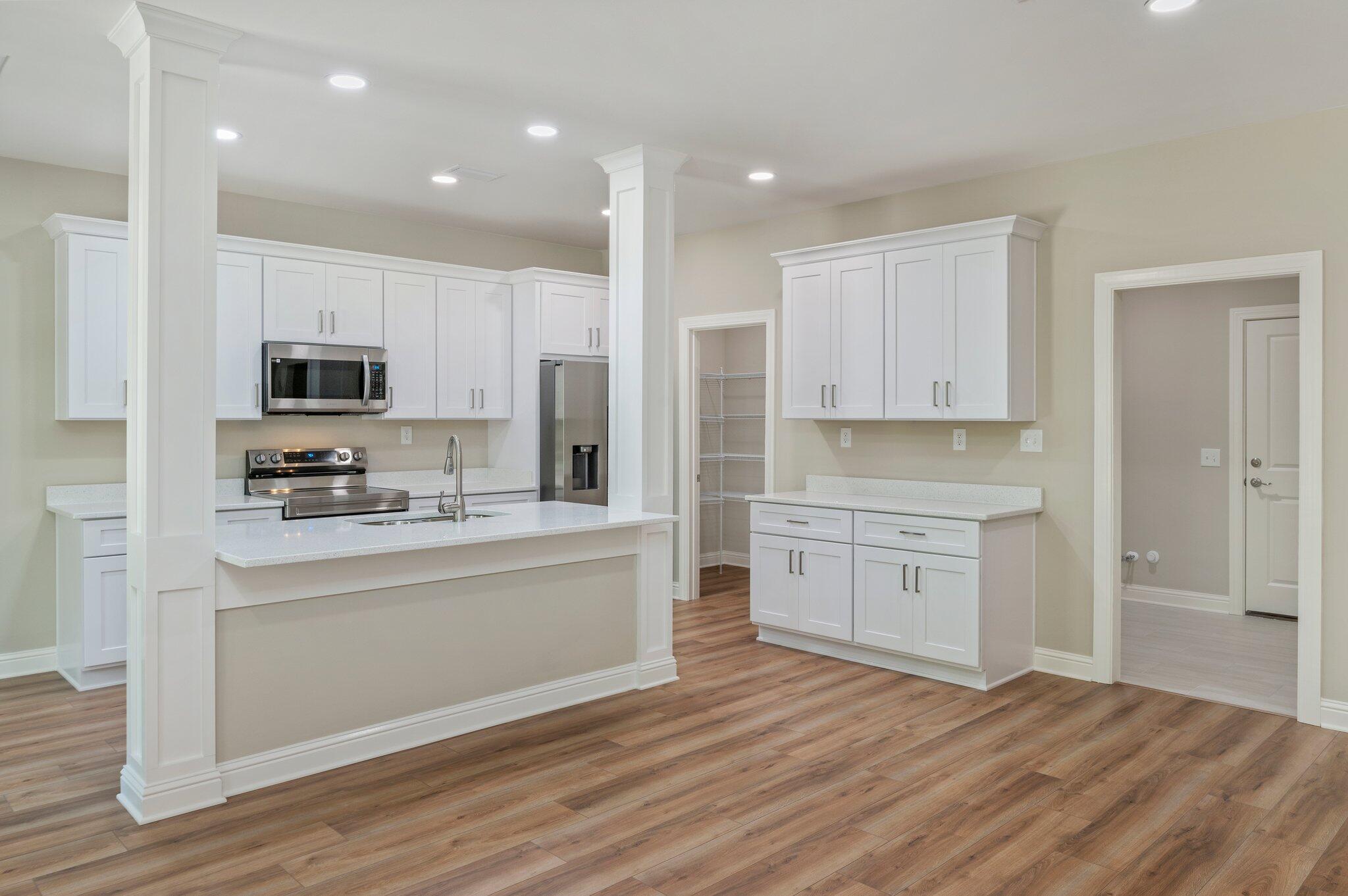 6043 Sand Hill Road Crestview, FL 32539 - Photo 11 of 36 a kitchen with stainless steel appliances a stove top oven a sink and a refrigerator