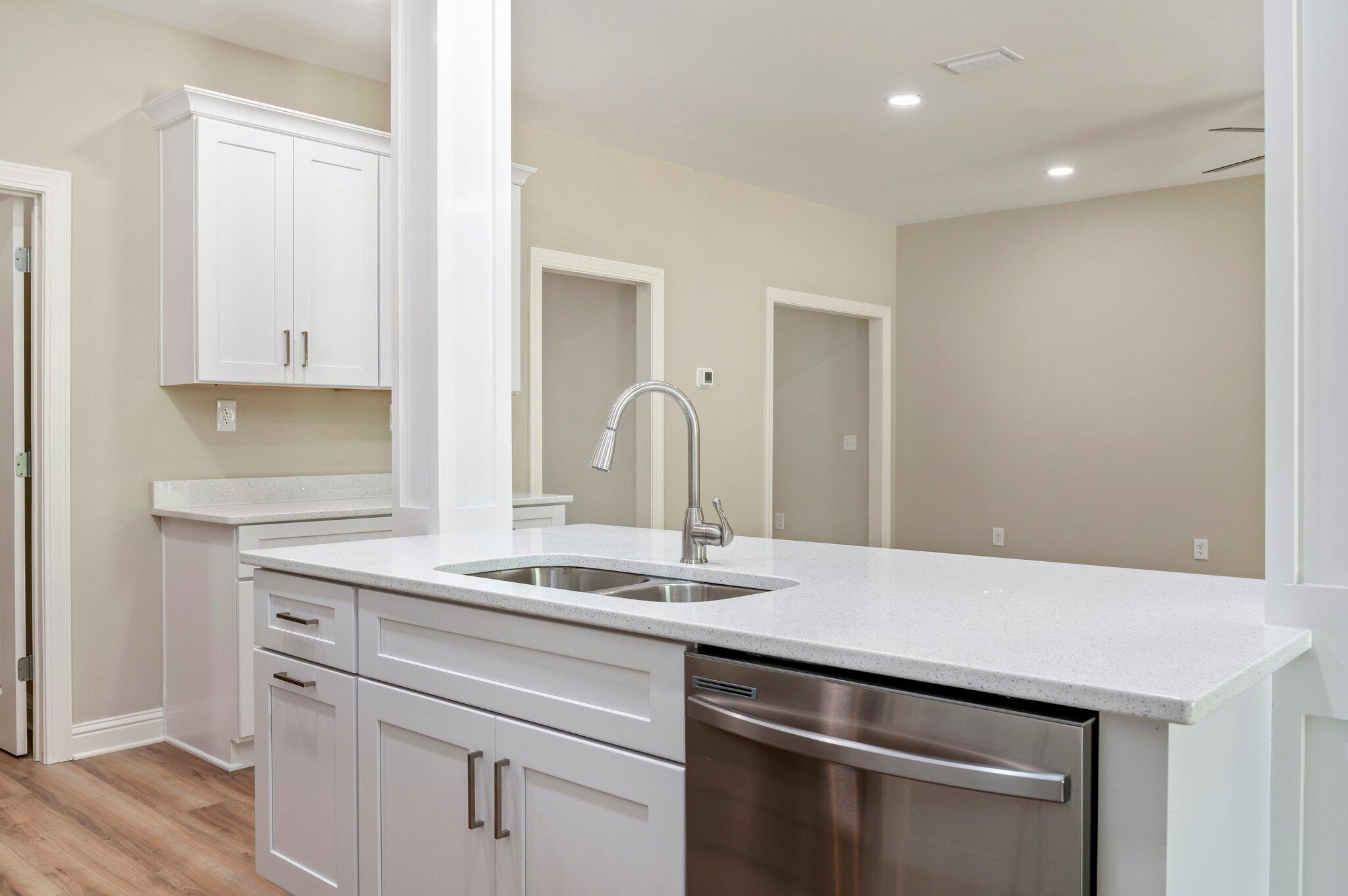 6043 Sand Hill Road Crestview, FL 32539 - Photo 13 of 36 a kitchen with granite countertop a sink and cabinets