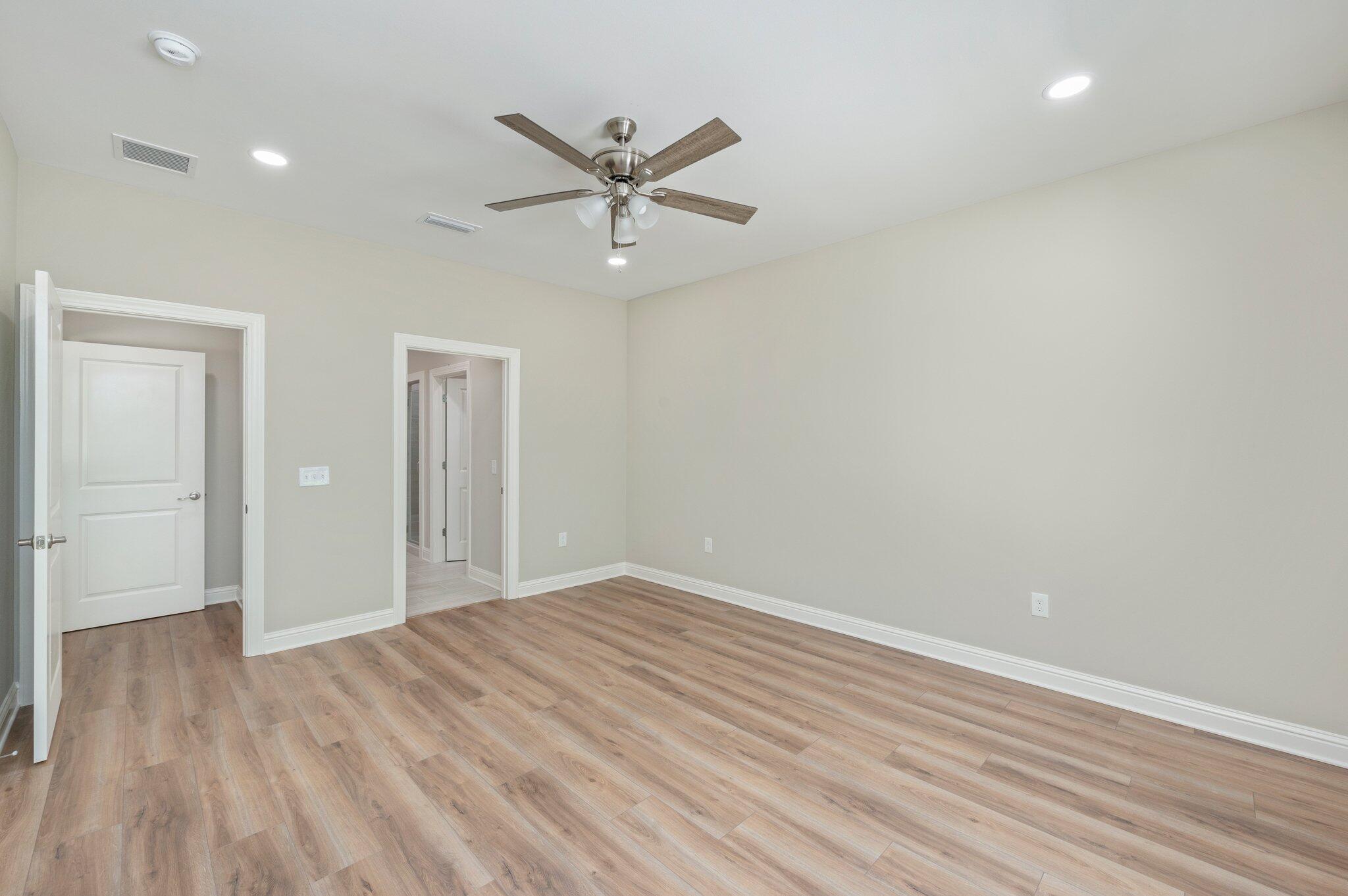 6043 Sand Hill Road Crestview, FL 32539 - Photo 18 of 36 wooden floor in an empty room with a window