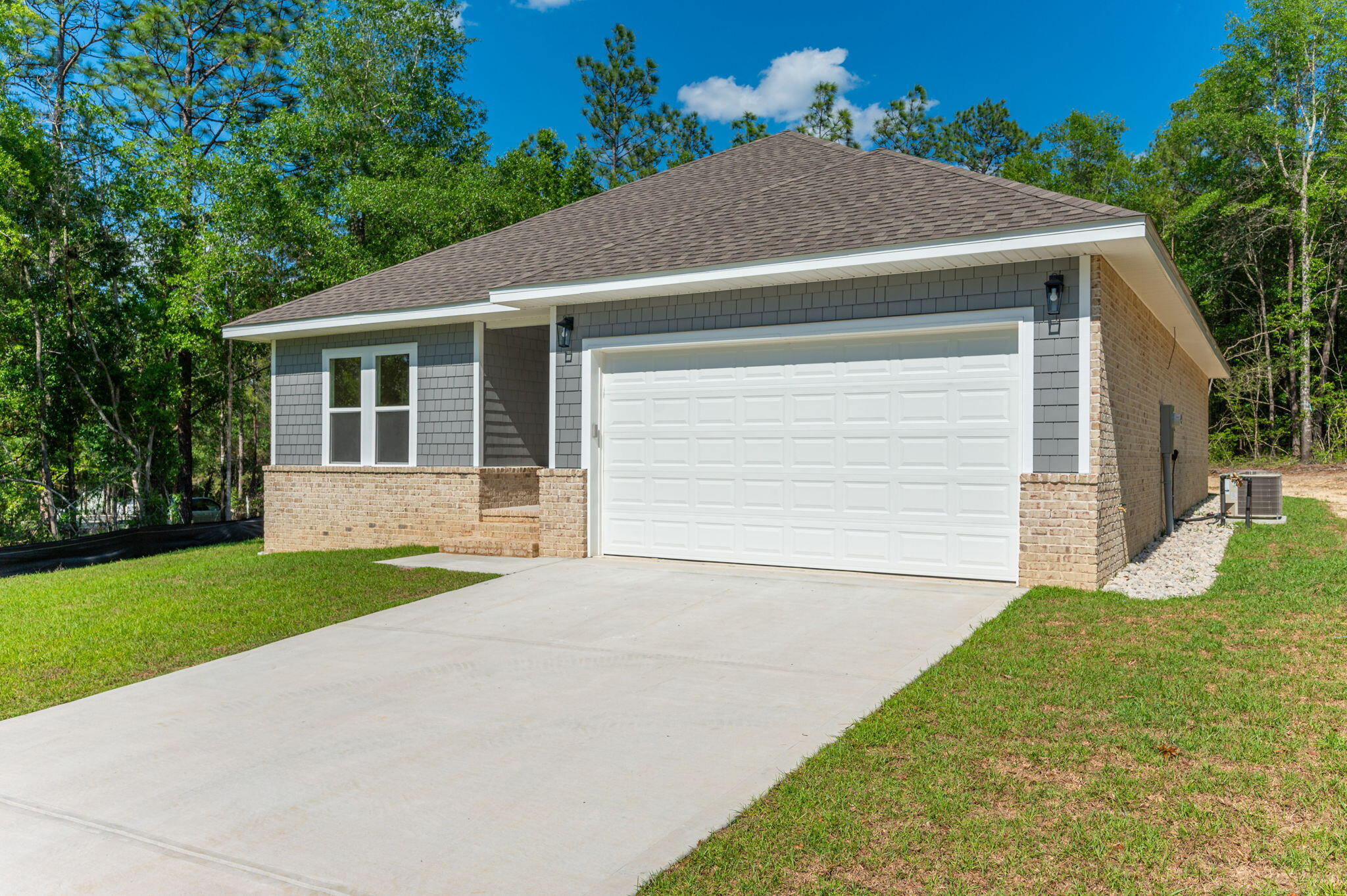 6043 Sand Hill Road Crestview, FL 32539 - Photo 2 of 36 a house with garden in front of it
