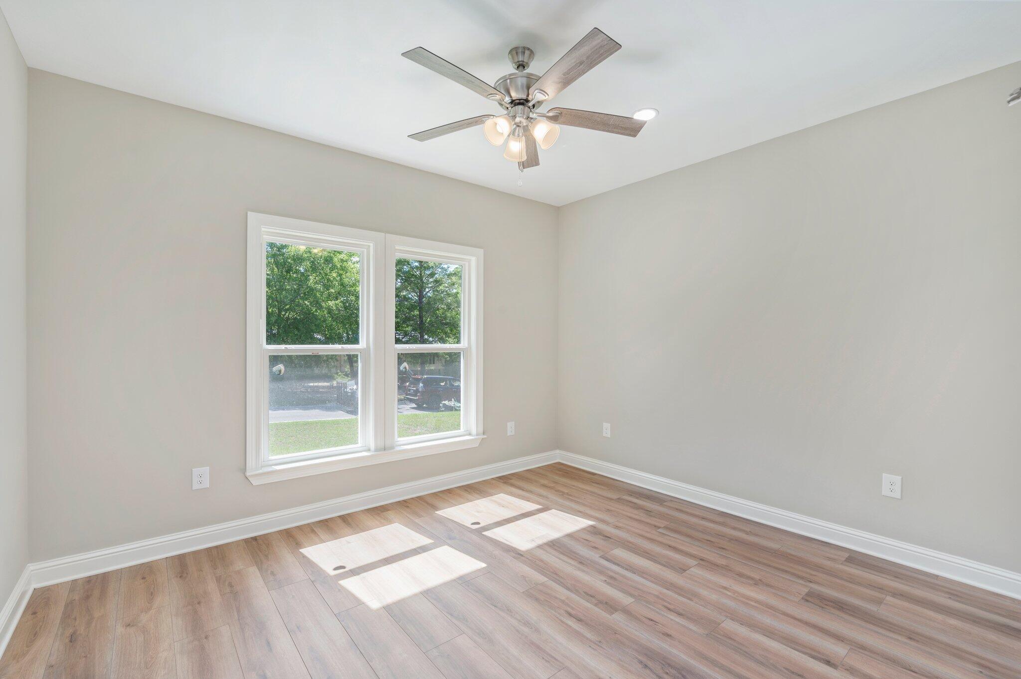 6043 Sand Hill Road Crestview, FL 32539 - Photo 25 of 36 wooden floor in an empty room with a window