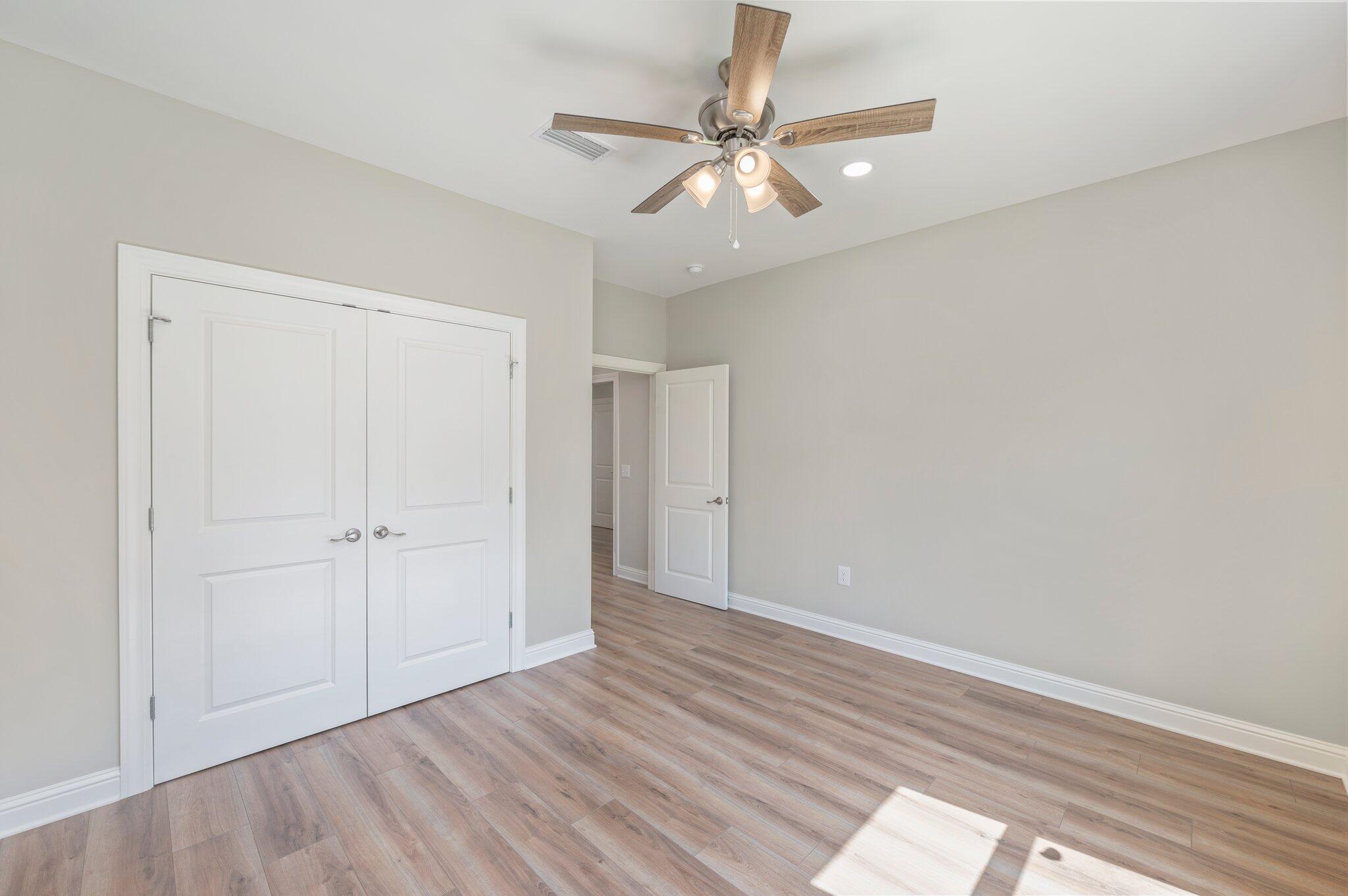 6043 Sand Hill Road Crestview, FL 32539 - Photo 26 of 36 wooden floor in an empty room
