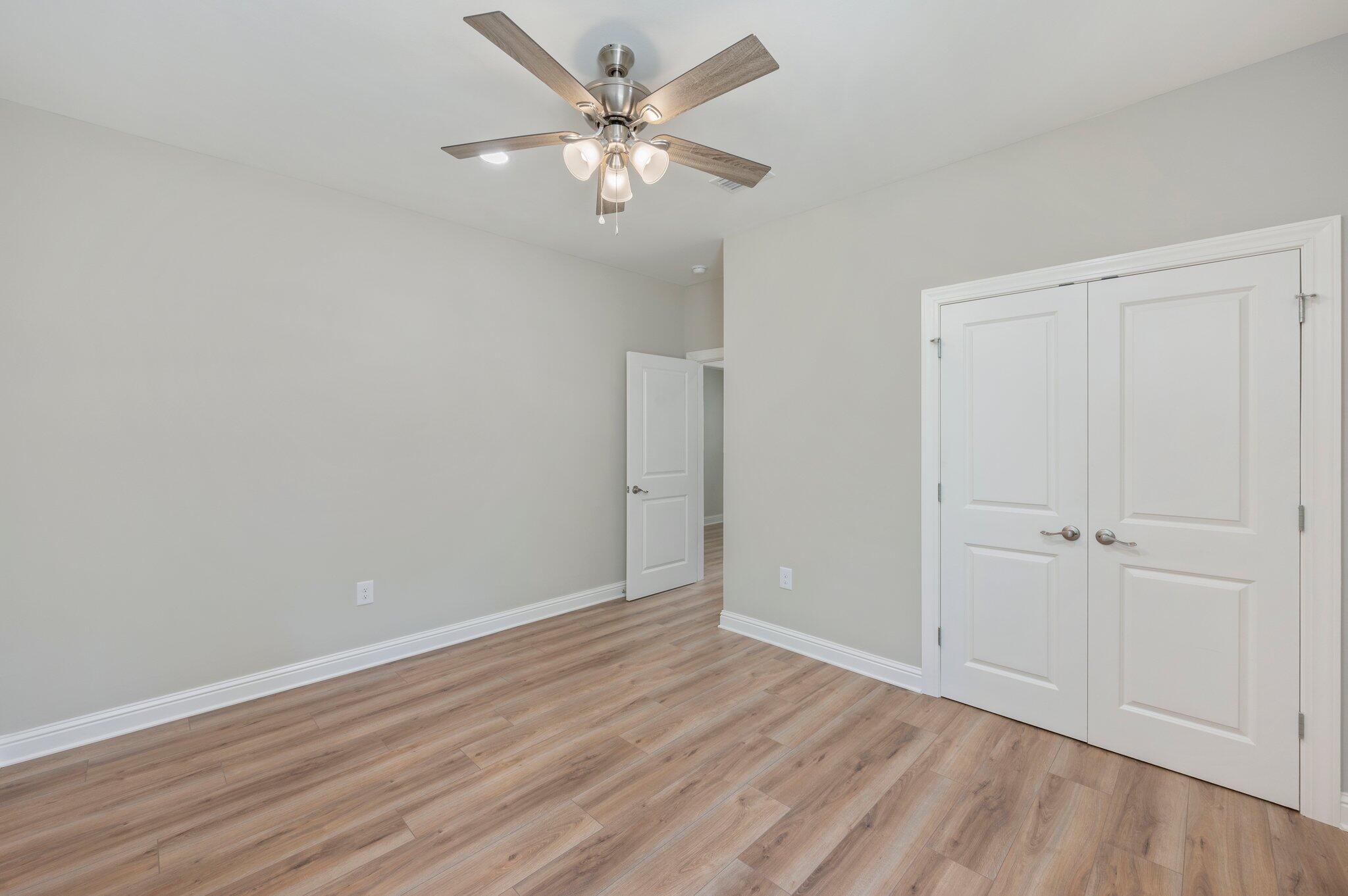 6043 Sand Hill Road Crestview, FL 32539 - Photo 28 of 36 a view of an empty room with wooden floor