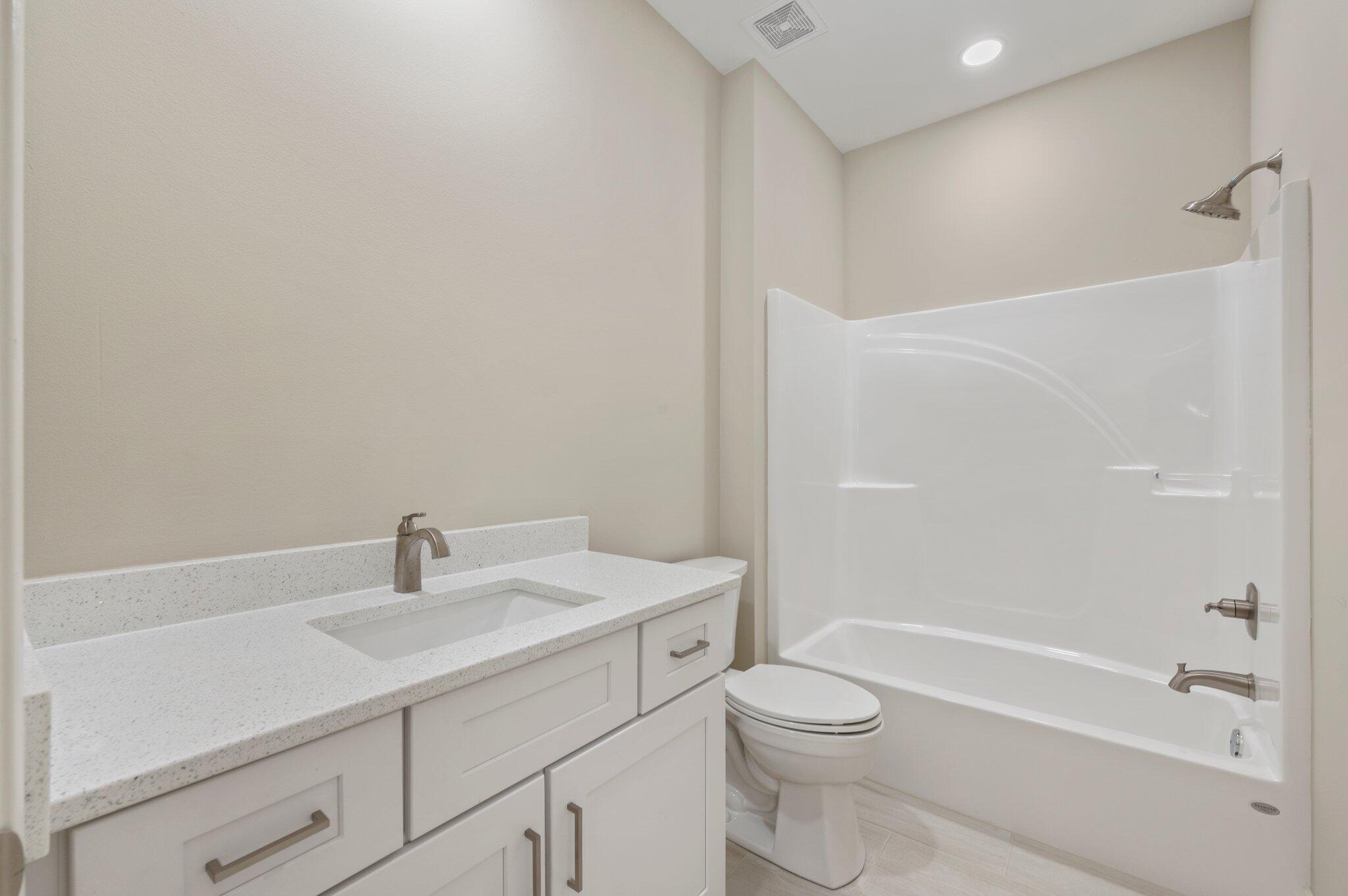 6043 Sand Hill Road Crestview, FL 32539 - Photo 29 of 36 a bathroom with a sink a toilet and shower