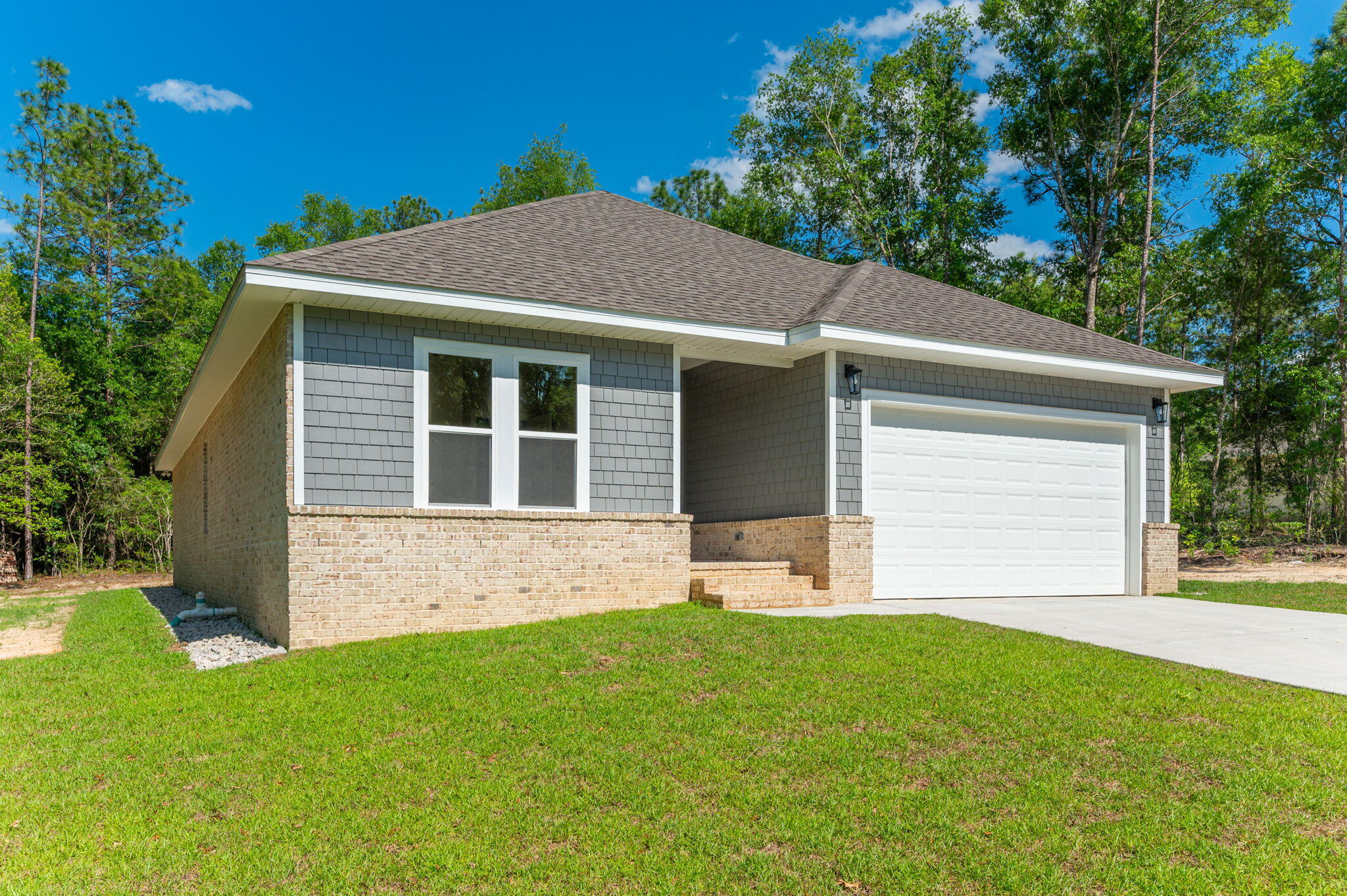 6043 Sand Hill Road Crestview, FL 32539 - Photo 3 of 36 a front view of a house with a yard and garage