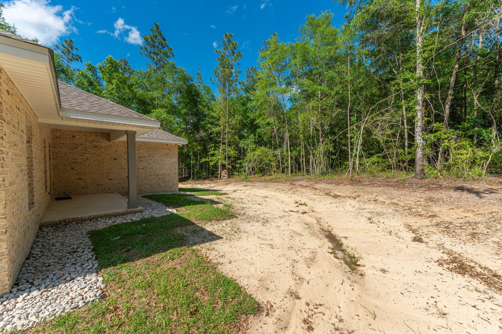 6043 Sand Hill Road Crestview, FL 32539 - Photo 34 of 36 a view of a backyard with a tree