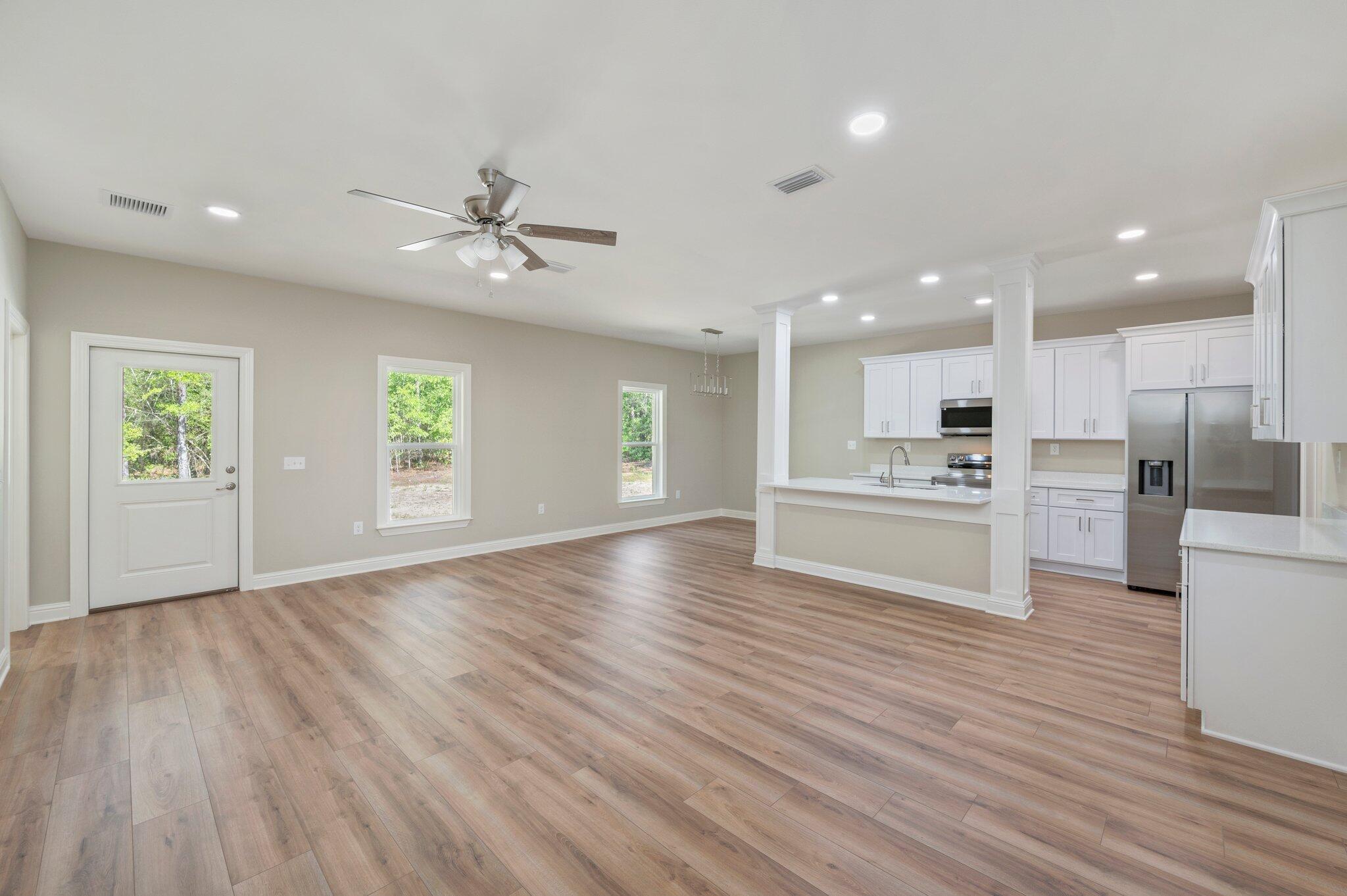6043 Sand Hill Road Crestview, FL 32539 - Photo 6 of 36 a view of kitchen with wooden floor and window