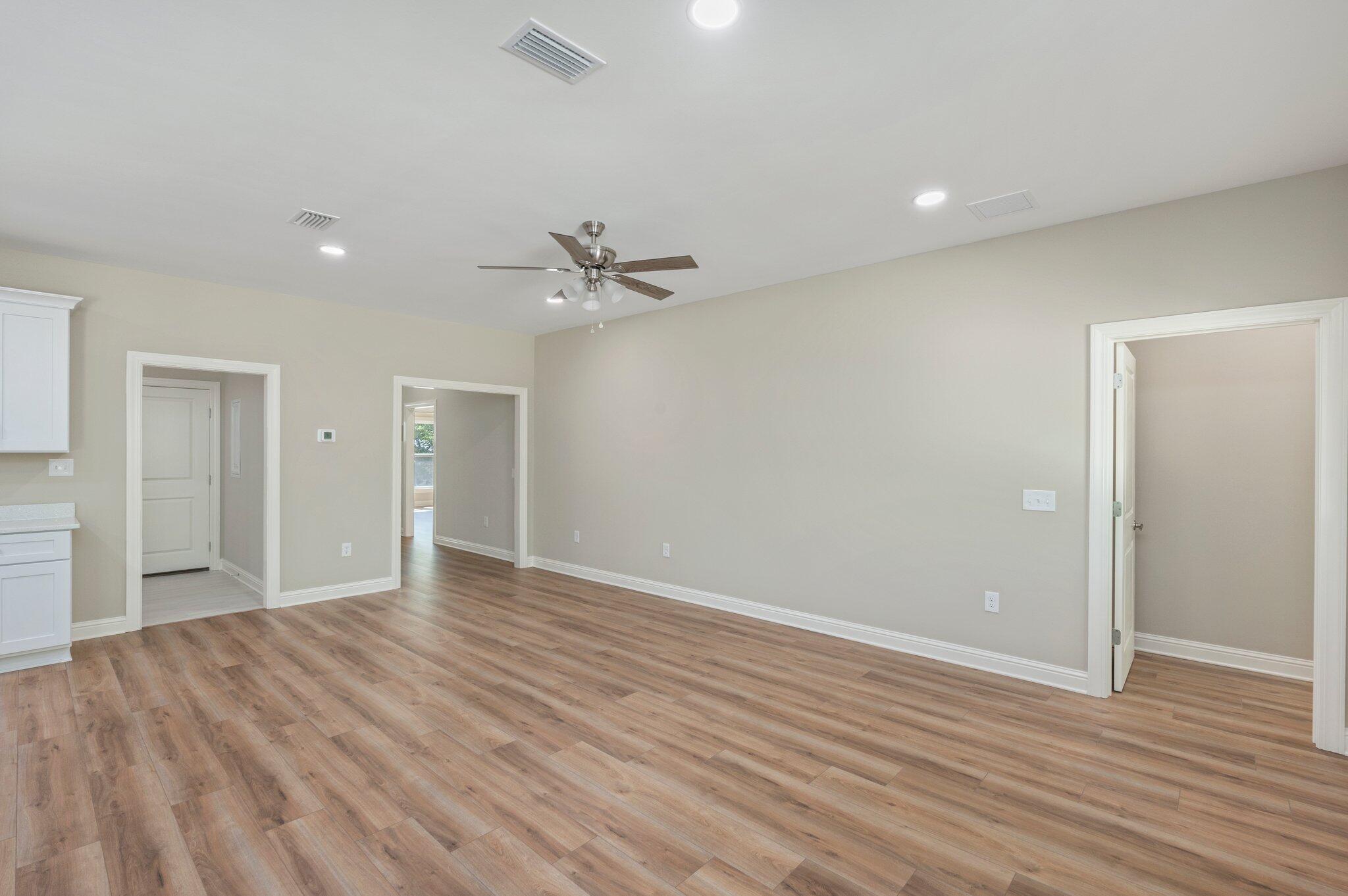 6043 Sand Hill Road Crestview, FL 32539 - Photo 8 of 36 a view of an empty room with wooden floor