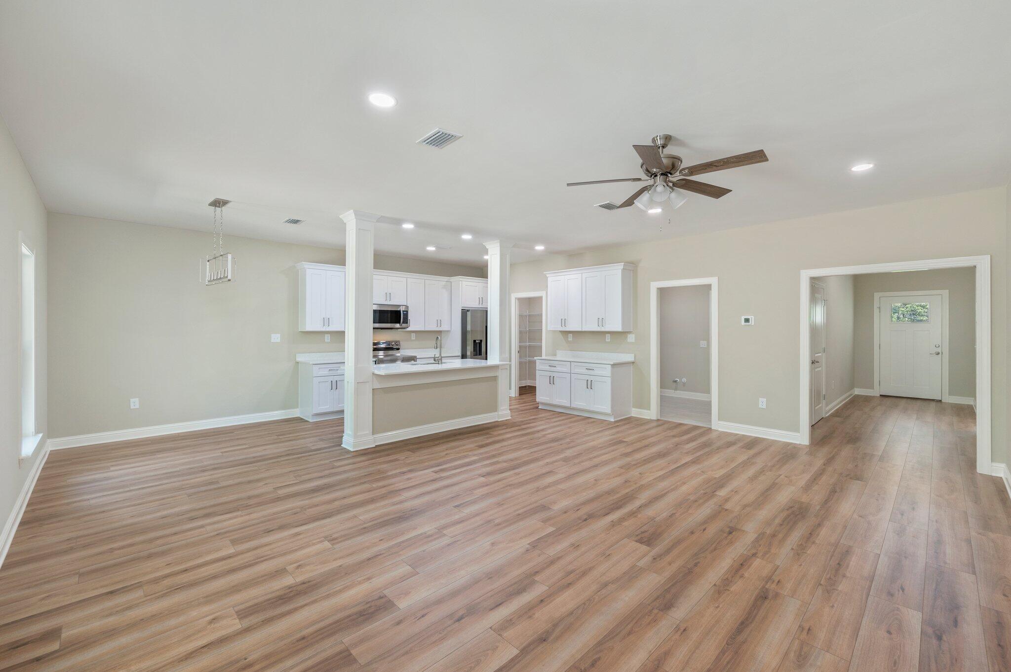 6043 Sand Hill Road Crestview, FL 32539 - Photo 9 of 36 a view of kitchen with cabinets and wooden floor