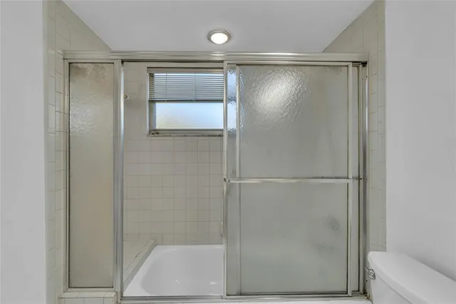 a bathroom with a glass shower door