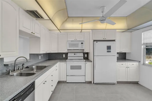 a kitchen with cabinets and white appliances