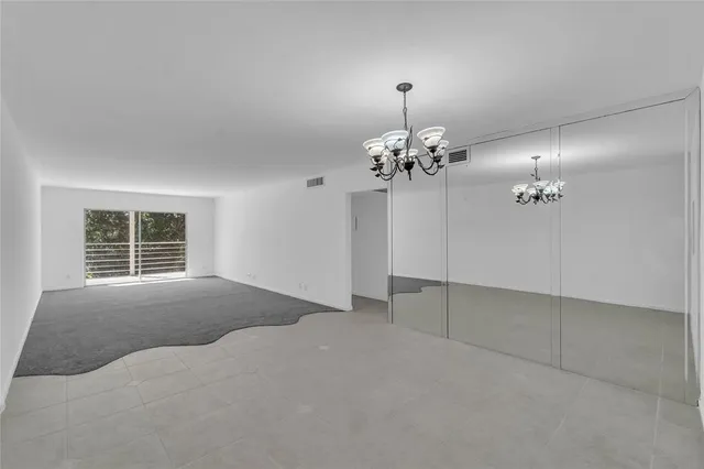 a view of a livingroom with a chandelier fan