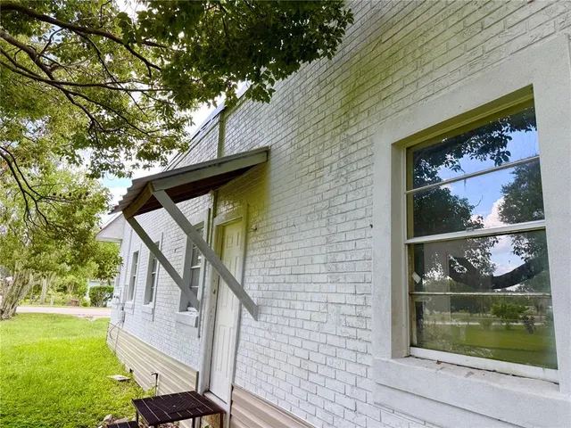 a view of a house with wooden deck