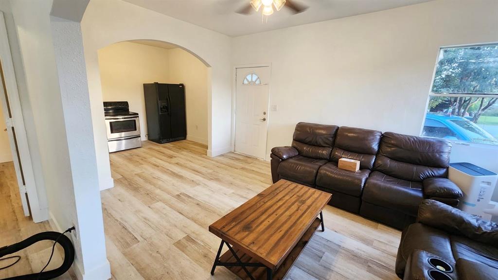 412 Bay Street Northwest Fort Meade, FL 33841 - Photo 2 of 14 a living room with furniture a flat screen tv and kitchen view