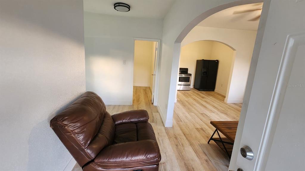 412 Bay Street Northwest Fort Meade, FL 33841 - Photo 7 of 14 a living room with furniture and a wooden floor