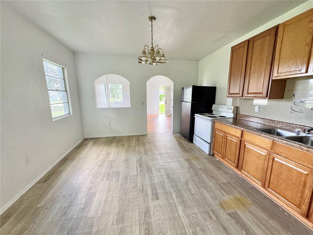 412 Bay Street Northwest Fort Meade, FL 33841 - Photo 10 of 14 a view of a kitchen counter space a sink wooden floor and a window
