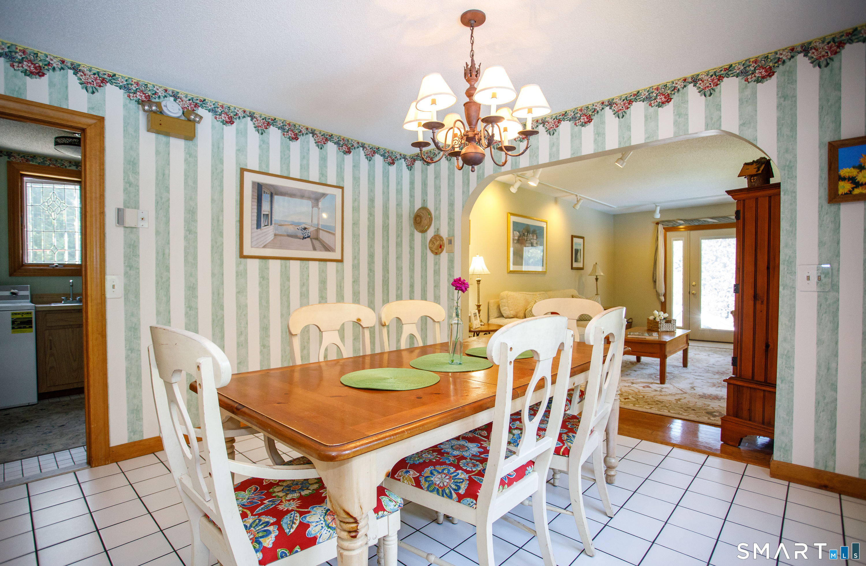 25 Stony Ridge Road Norwich, CT 06360 - Photo 6 of 40 a dining room with wooden floor a chandelier a wooden table and chairs