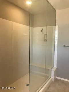 a bathroom with a glass shower door